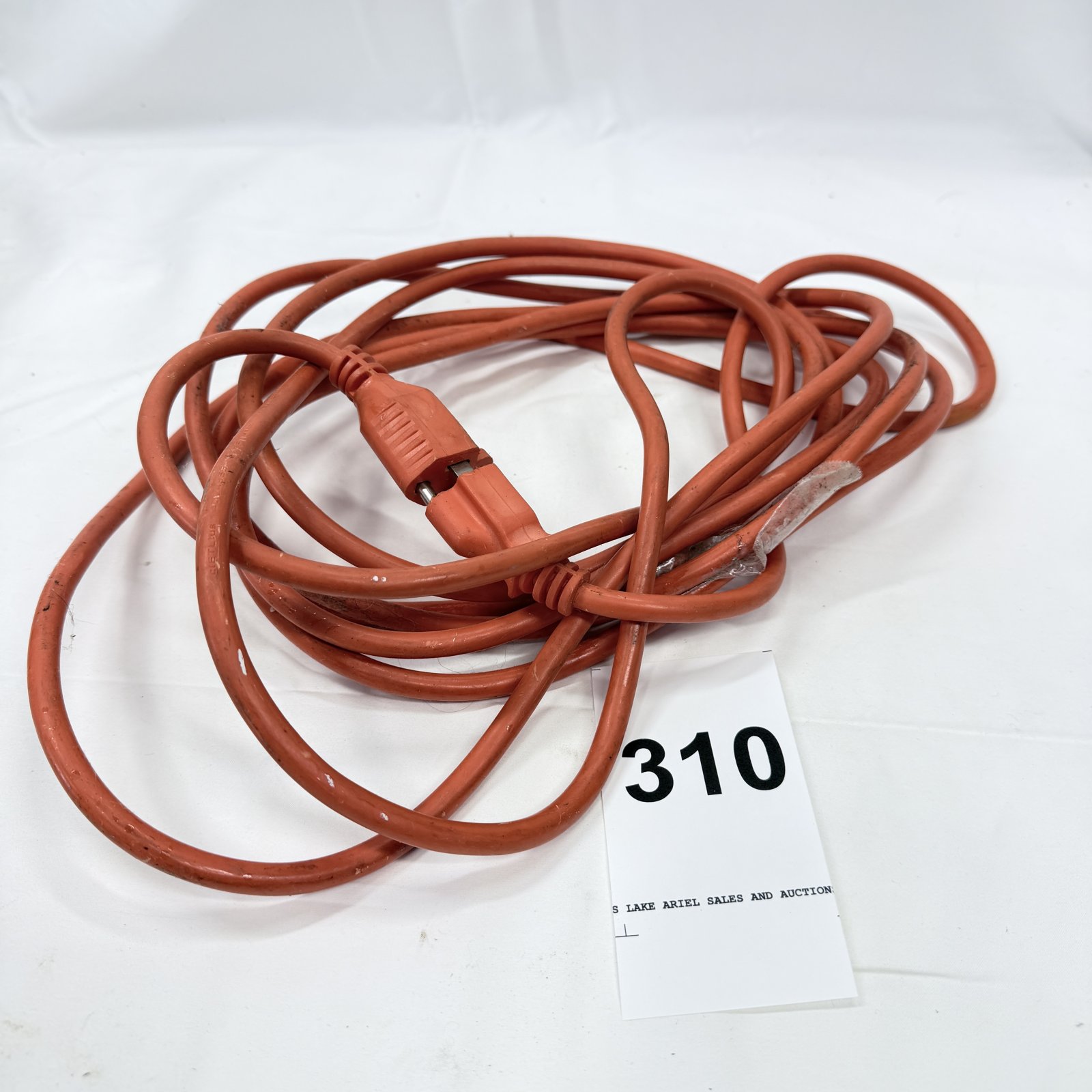 Lot 310: Heavy-duty 2-wire orange extension cord, approximately 25ft, with repaired end
