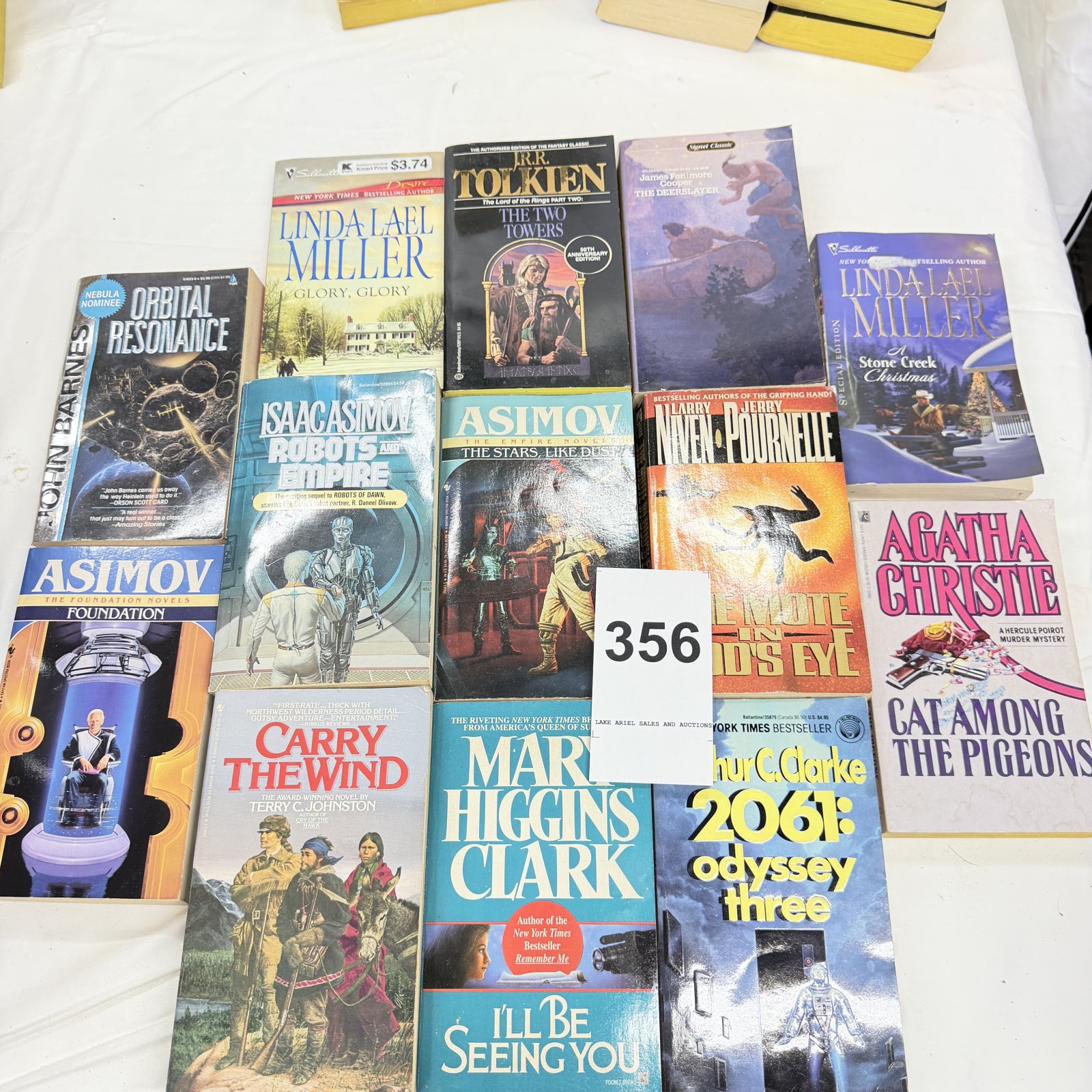 Lot 356: Paperback book lot (15): Asimov Foundation/Empire/Robots series, Tolkien "The Two Towers," Clarke "2061," Agatha Christie, Mary Higgins Clark