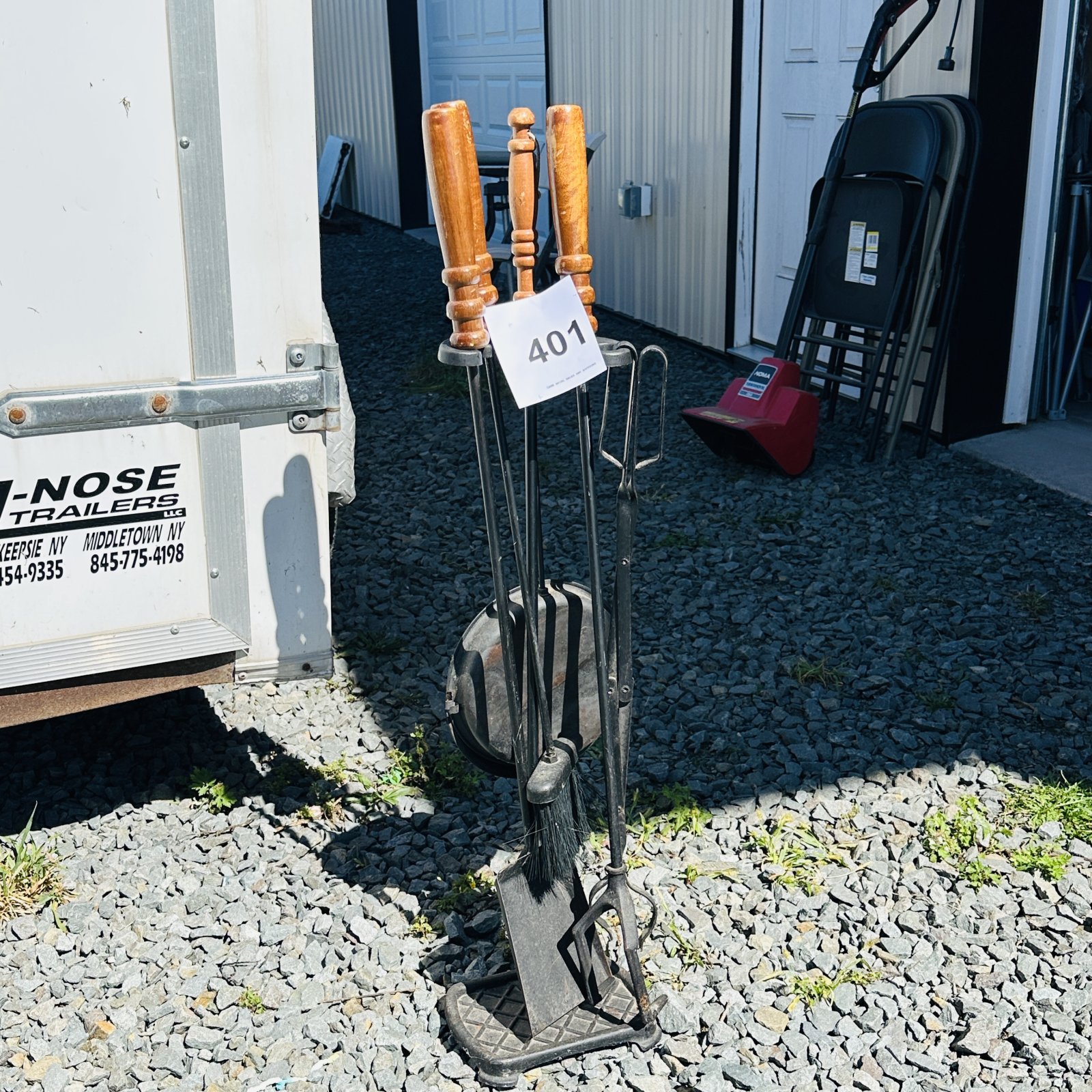 Lot 401:  cast iron fireplace tool set with stand, wood handles, broom/shovel/poker/tongs