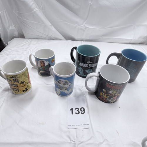 Lot 139: Lot of 6 Disney Theme Park Mugs - Toy Story, Haunted Mansion, Tomorrowland