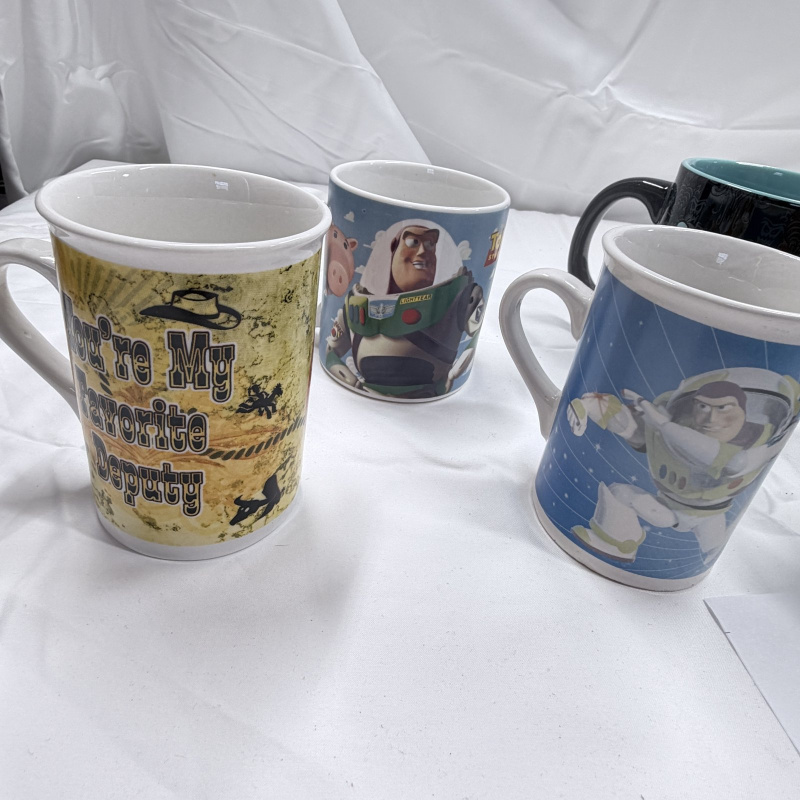 Lot 139: Lot of 6 Disney Theme Park Mugs - Toy Story, Haunted Mansion, Tomorrowland