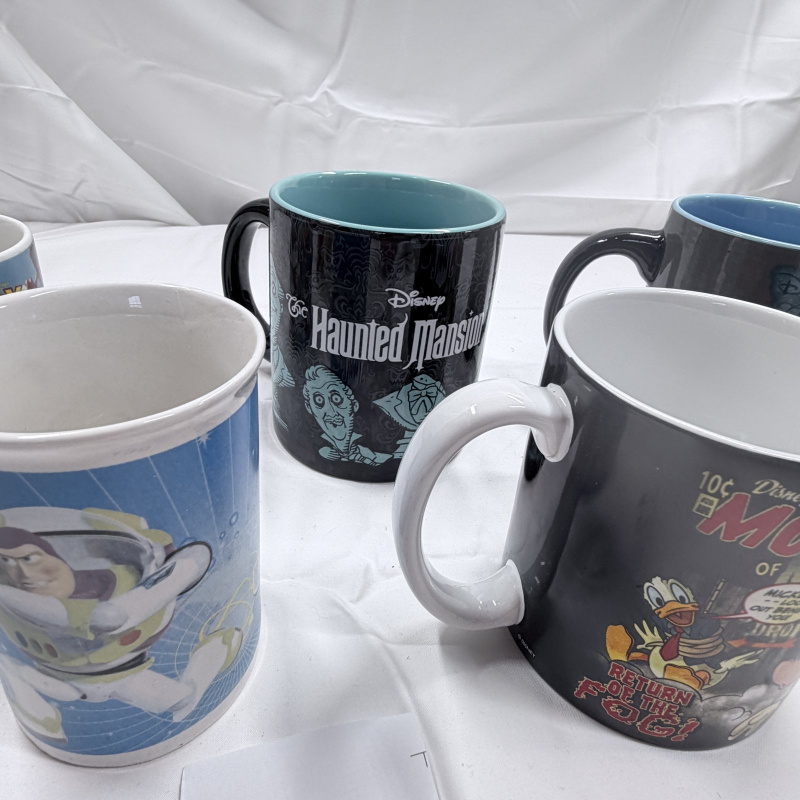 Lot 139: Lot of 6 Disney Theme Park Mugs - Toy Story, Haunted Mansion, Tomorrowland