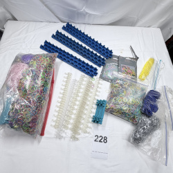 Lot 228: Rainbow Loom Rubber Bands & Clear Plastic C-Clips with Blue Storage Racks
