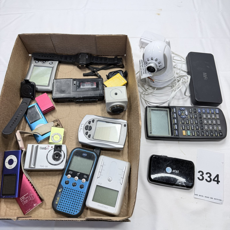 Lot 334: Mixed Lot Vintage Electronics: Cameras, GPS, Calculator, MP3 Players, Walkie-Talkie