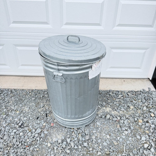 Lot 649: Vintage galvanized steel 20-gallon garbage can with lid, ribbed body and swing handles