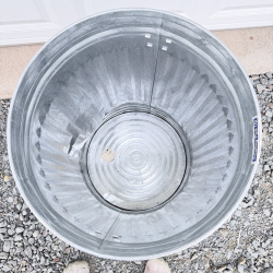 Lot 649: Vintage galvanized steel 20-gallon garbage can with lid, ribbed body and swing handles