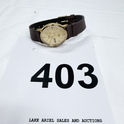 Lot 403: Vintage Timex Quartz men's wristwatch, gold-tone case with day/date, brown lizard-embossed leather strap