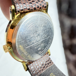 Lot 403: Vintage Timex Quartz men's wristwatch, gold-tone case with day/date, brown lizard-embossed leather strap
