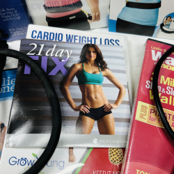 Lot 415: Fitness equipment lot: Flex Belt, Leslie Sansone Walk at Home DVD kits, resistance bands, PiYo, Body Beast, 21 Day Fix DVDs