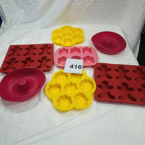 Lot 416: Wilton silicone bakeware lot: "Tulips & Daisies" flower molds, gingerbread man molds, and deviled egg trays, 7 pieces