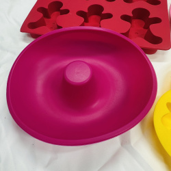 Lot 416: Wilton silicone bakeware lot: "Tulips & Daisies" flower molds, gingerbread man molds, and deviled egg trays, 7 pieces
