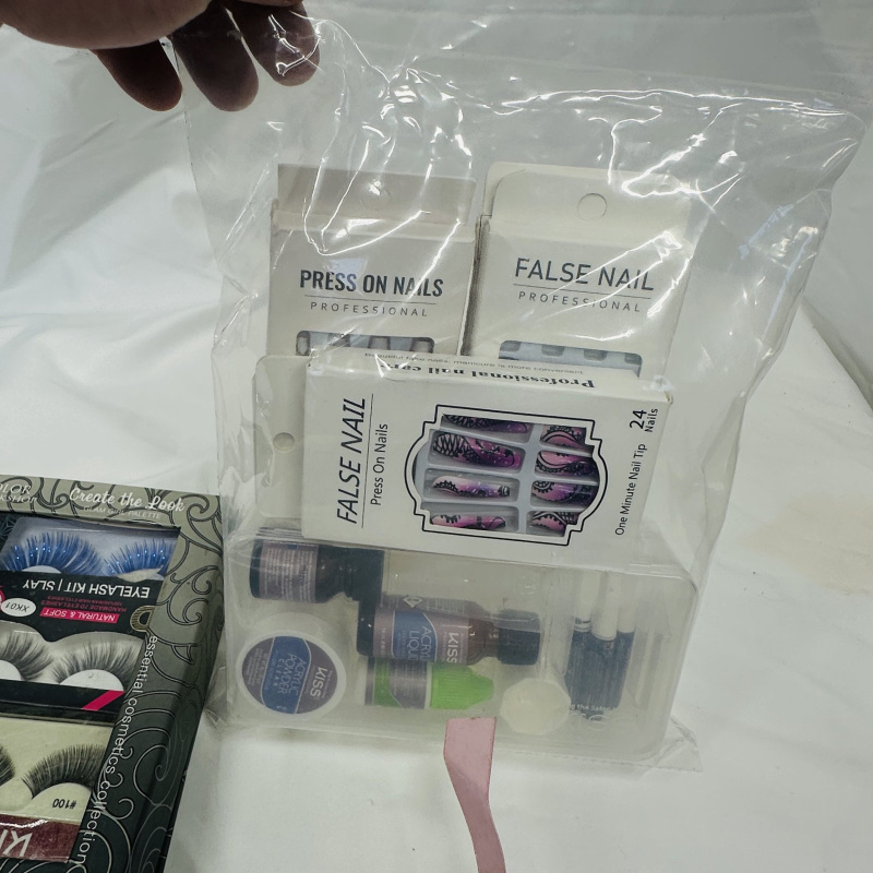 Lot 422: Cosmetics lot: KISS Eyelash Kit "Create the Look" Glam Girl Palette, False Nail Press-On Nail sets, KISS Acrylic Nail Kit, Simple Pleasures "Shine All The Way" 14-piece Nail Polish Collection