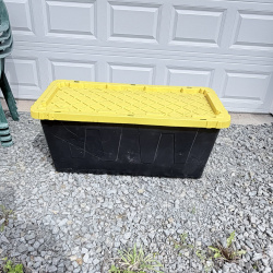 Lot 652: HDX "Tough Tote" 55 gallon storage container, black base with yellow lid, stackable/lockable