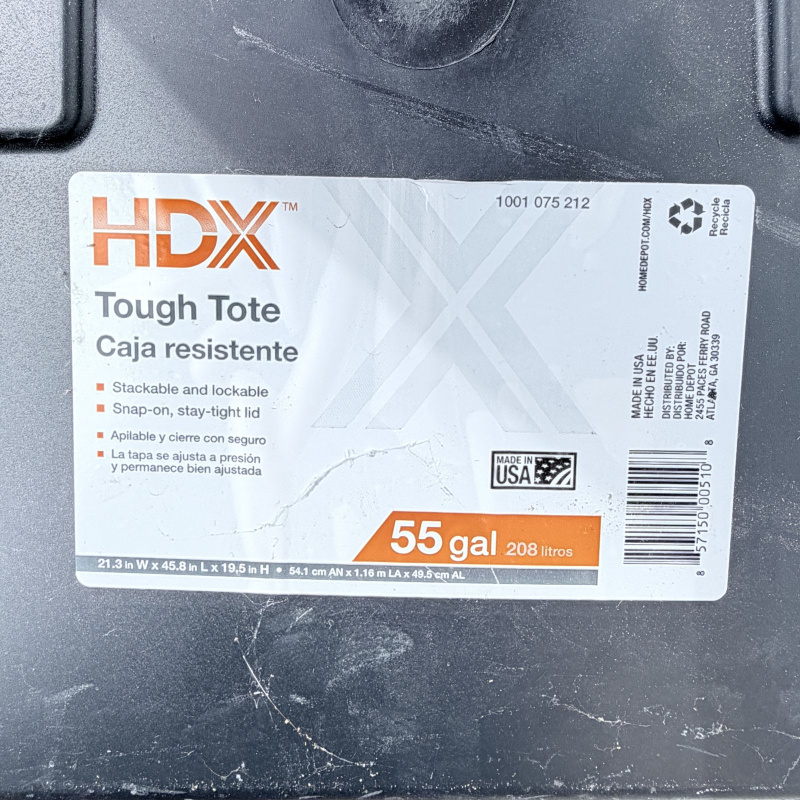 Lot 652: HDX "Tough Tote" 55 gallon storage container, black base with yellow lid, stackable/lockable