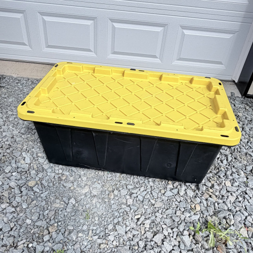 Lot 653: HDX "Tough Tote" 38 gallon storage container with lid, black/yellow, made in USA