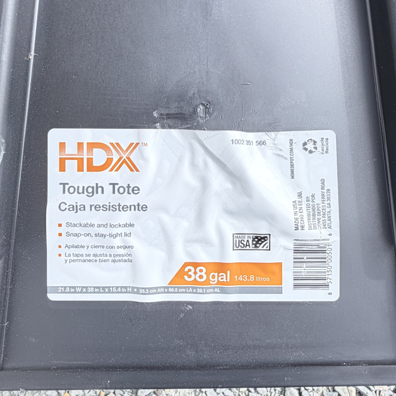 Lot 653: HDX "Tough Tote" 38 gallon storage container with lid, black/yellow, made in USA