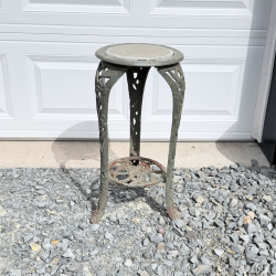 Lot 654: Vintage cast aluminum tri-leg plant stand with floral motif and stone/tile inset top, garden fern & flower design