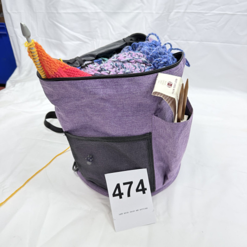 Lot 474: Knitting/crochet tote bag with yarn, crochet hooks, and knitting needles, purple crafter's project bag