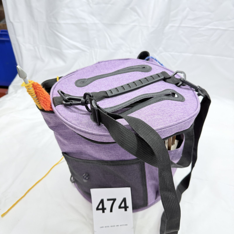 Lot 474: Knitting/crochet tote bag with yarn, crochet hooks, and knitting needles, purple crafter's project bag