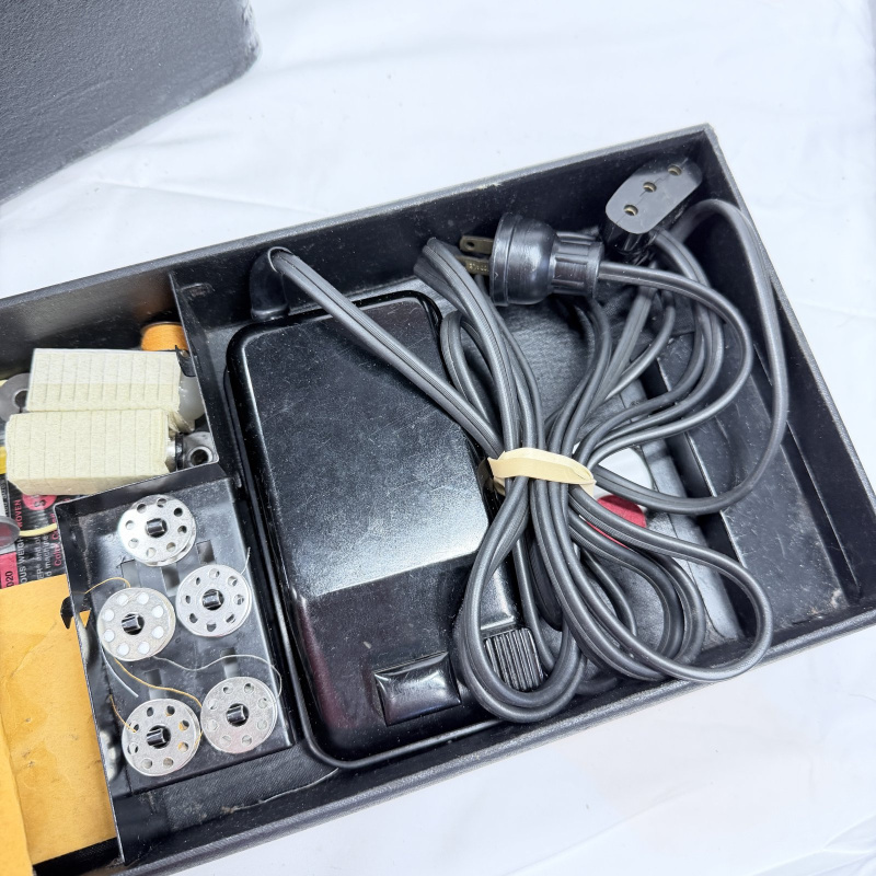 Lot 493: Vintage Singer Featherweight 221 portable electric sewing machine with black case, foot pedal, bobbins & accessories