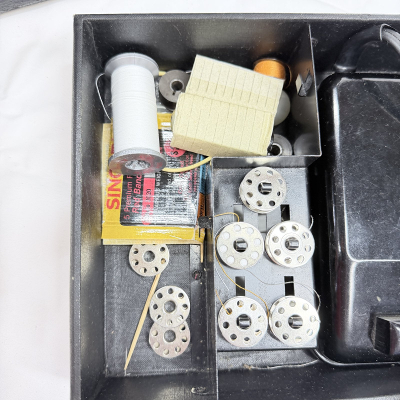 Lot 493: Vintage Singer Featherweight 221 portable electric sewing machine with black case, foot pedal, bobbins & accessories