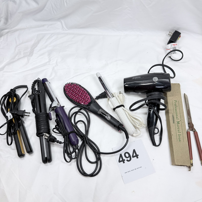 Lot 494: Vintage hair styling tool lot: Sunbeam Hospitality dryer, Simply Straight brush, curling irons, flat irons, and vintage Professional Marcel Iron in box