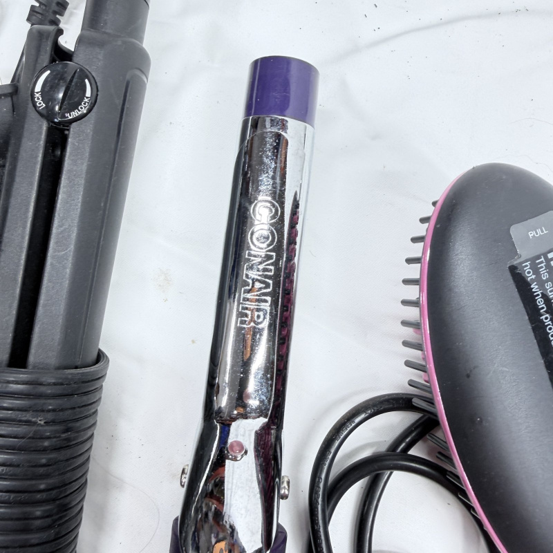 Lot 494: Vintage hair styling tool lot: Sunbeam Hospitality dryer, Simply Straight brush, curling irons, flat irons, and vintage Professional Marcel Iron in box