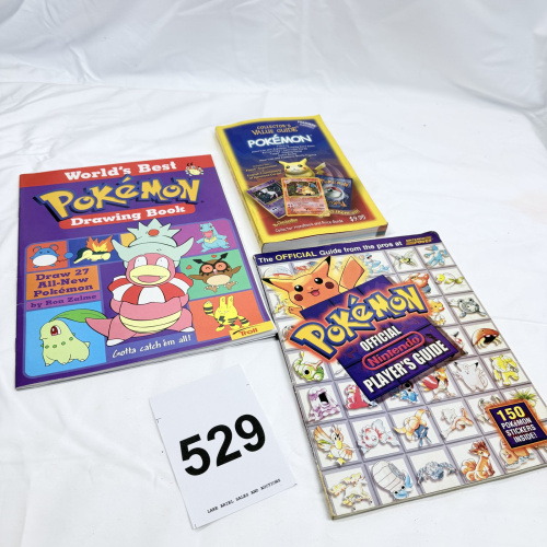 Lot 529: Pokémon book lot: World's Best Pokémon Drawing Book (Troll), Collector's Value Guide Premiere Edition, Nintendo Power Official Player's Guide w/ stickers