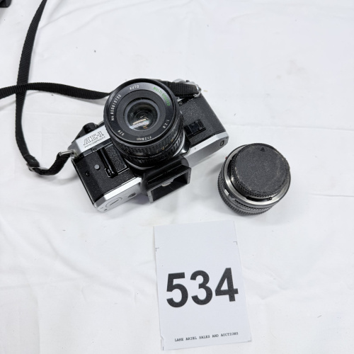 Lot 534: Vintage Canon AE-1 Program 35mm SLR camera with 28mm f/2.8 lens and additional lens