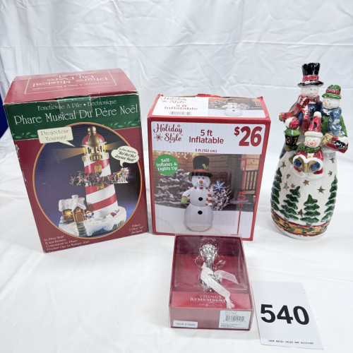 Lot 540: Christmas lot: Musical Père Noël lighthouse, Holiday Style 5ft inflatable snowman, Things Remembered glass baby rattle, and ceramic snowman family figurine