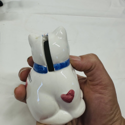 Lot 548: Vintage porcelain cat figurine lot: kitten, sofa planter, candle holder, and coin bank, set of 4