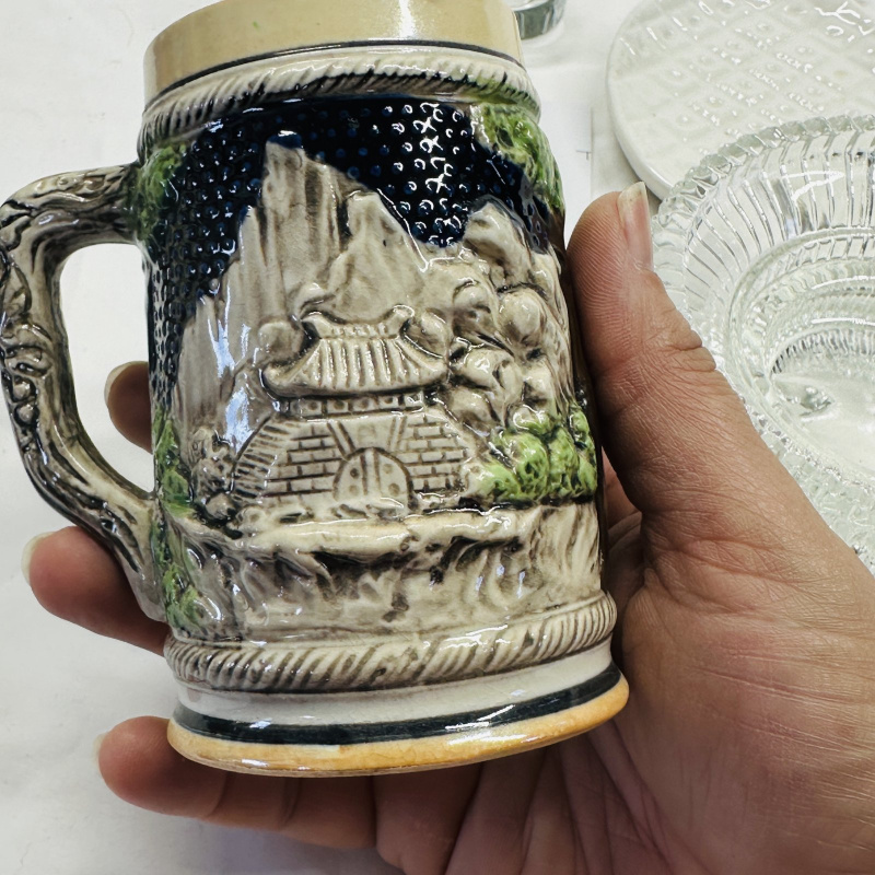 Lot 549: Vintage Japan ceramic beer stein with relief pagoda scene, glass bowl/tray lot with brass-topped ceramic pineapple dish