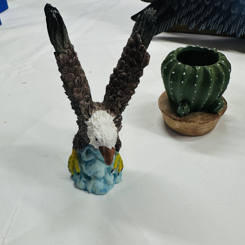 Lot 551: Mixed lot: resin bear/eagle figurines, apple-motif ceramic crock, honey pot, holly glass bud vase, wooden eagle wall decor, thimble