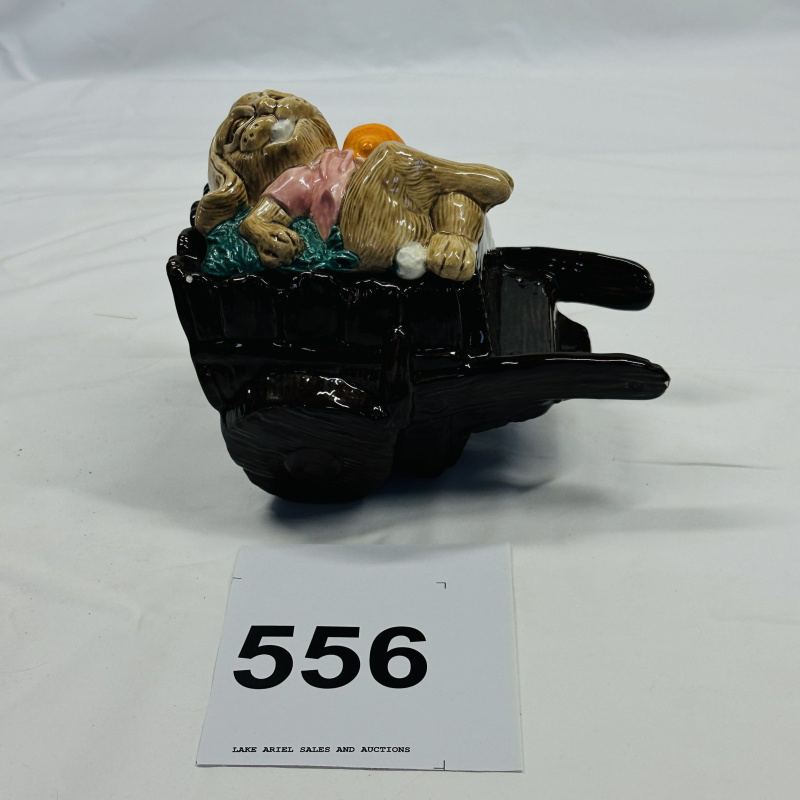 Lot 556: Majolica-style rabbit sleeping in wheelbarrow figural planter/dish, sculpted ceramic