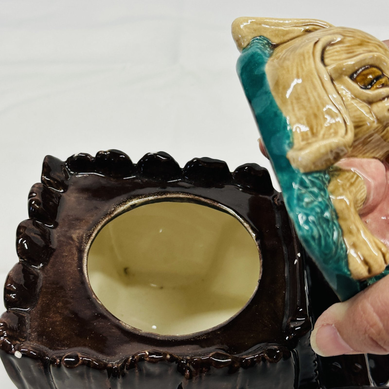 Lot 556: Majolica-style rabbit sleeping in wheelbarrow figural planter/dish, sculpted ceramic