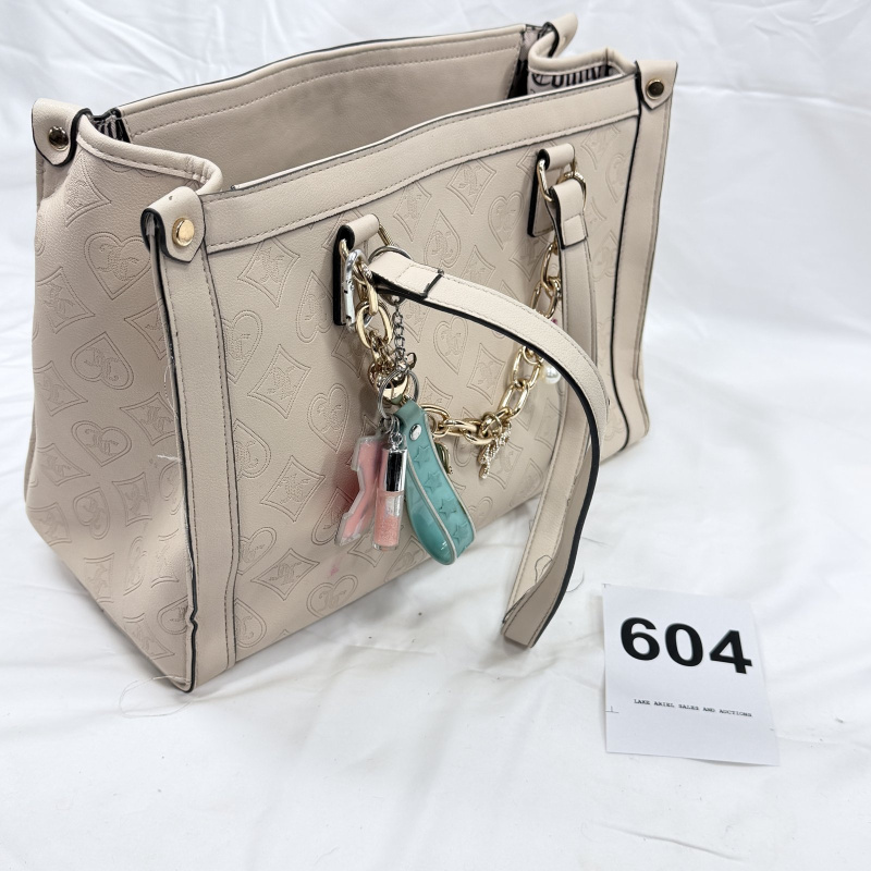 Lot 604: Juicy Couture cream embossed monogram leather tote bag with chain-link handle and charm keyring, includes lipstick stain