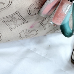 Lot 604: Juicy Couture cream embossed monogram leather tote bag with chain-link handle and charm keyring, includes lipstick stain