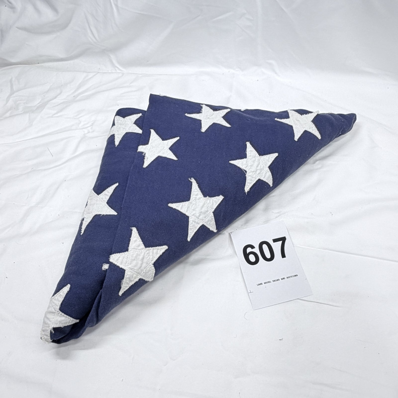 Lot 607: Vintage American flag, embroidered stars, ceremonially folded