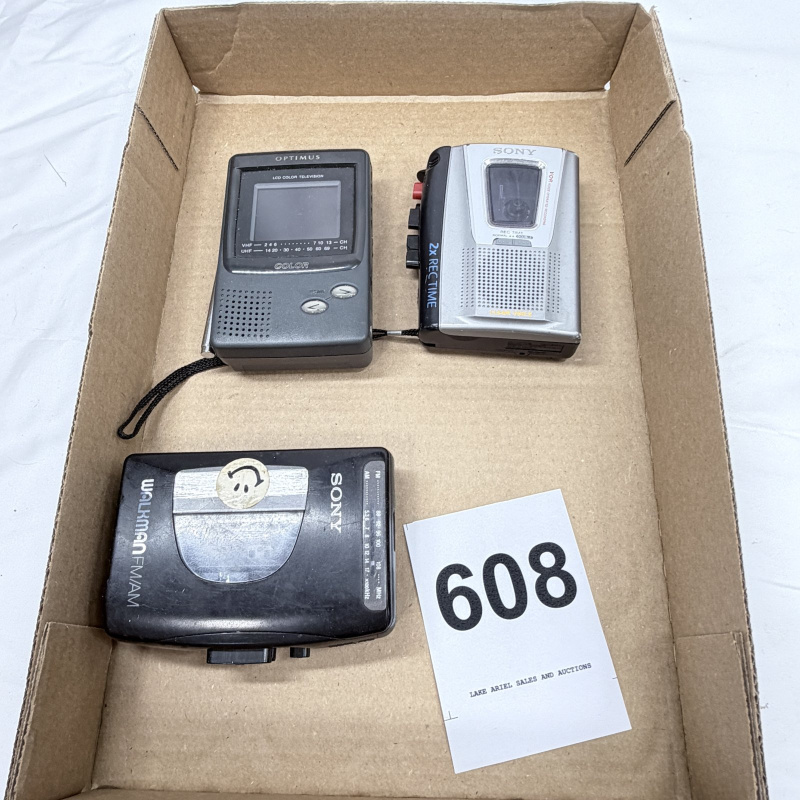 Lot 608: Vintage electronics lot: Optimus LCD Color Television, Sony VOR handheld cassette recorder, Sony Walkman FM/AM cassette player