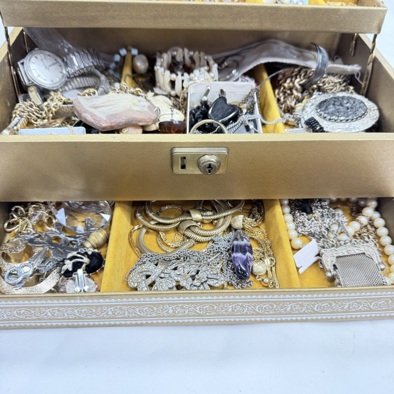 Lot 631: Vintage gold-tone three-tier jewellery box with costume jewellery collection, watches, necklaces, brooches and cameos
