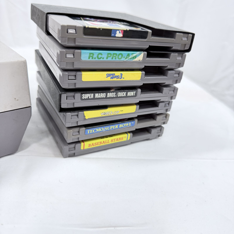 Lot 632: Vintage Nintendo Entertainment System (NES) console with controller, Zapper light gun, and 7 games including Super Mario Bros. 3