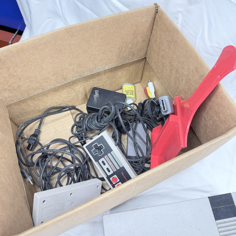 Lot 632: Vintage Nintendo Entertainment System (NES) console with controller, Zapper light gun, and 7 games including Super Mario Bros. 3