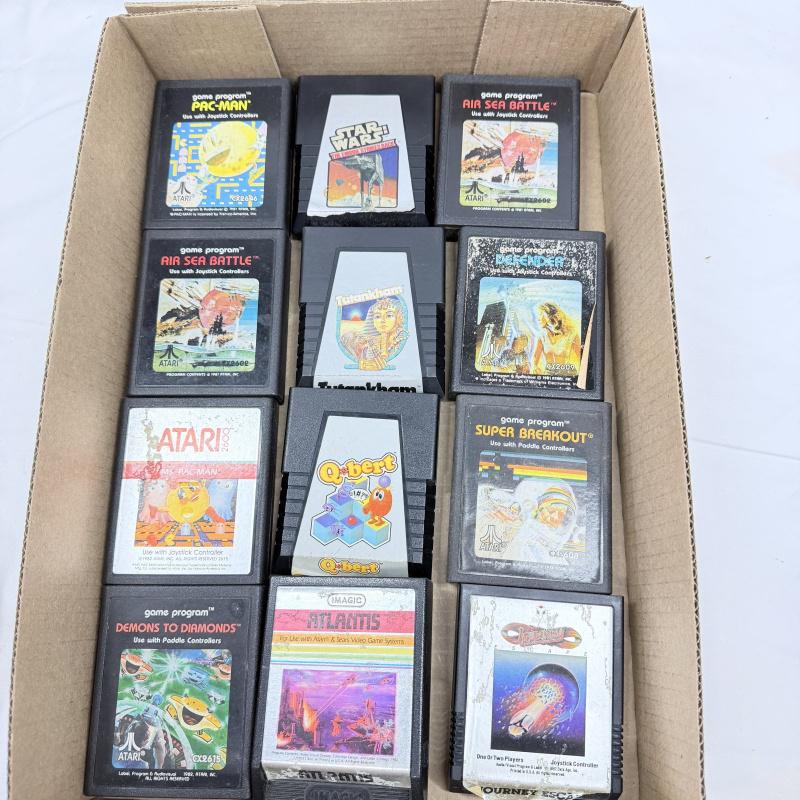 Lot 634: 1980s Atari 2600 game cartridge lot (12): Pac-Man, Ms. Pac-Man, Q*bert, Defender, Star Wars, Atlantis, Super Breakout, Tutankham, Journey Escape