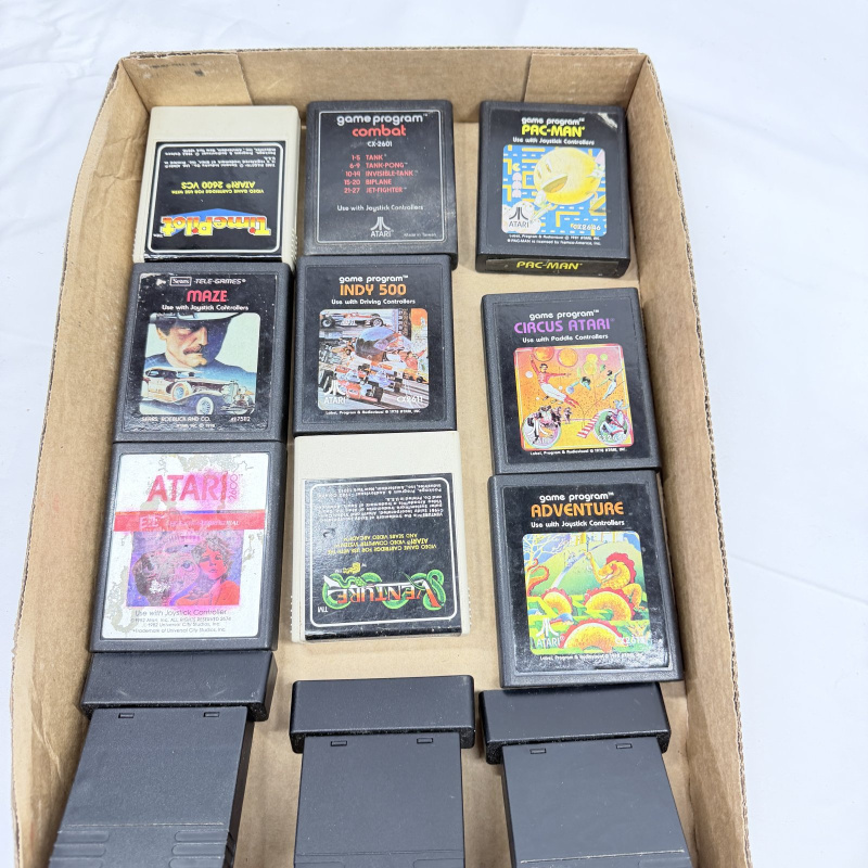 Lot 636: Vintage Atari 2600 game cartridge lot (12): Pac-Man, Adventure, Combat, Venture, Indy 500, Circus Atari, Maze, E.T., Time Pilot, Frogs and Flies, Super Challenge Baseball, Armor Ambush