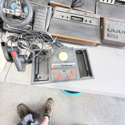 Lot 642: Vintage Atari 2600/CX2600 & ColecoVision console lot with Sears Tele-Games, controllers, joysticks and Coleco Roller Controller