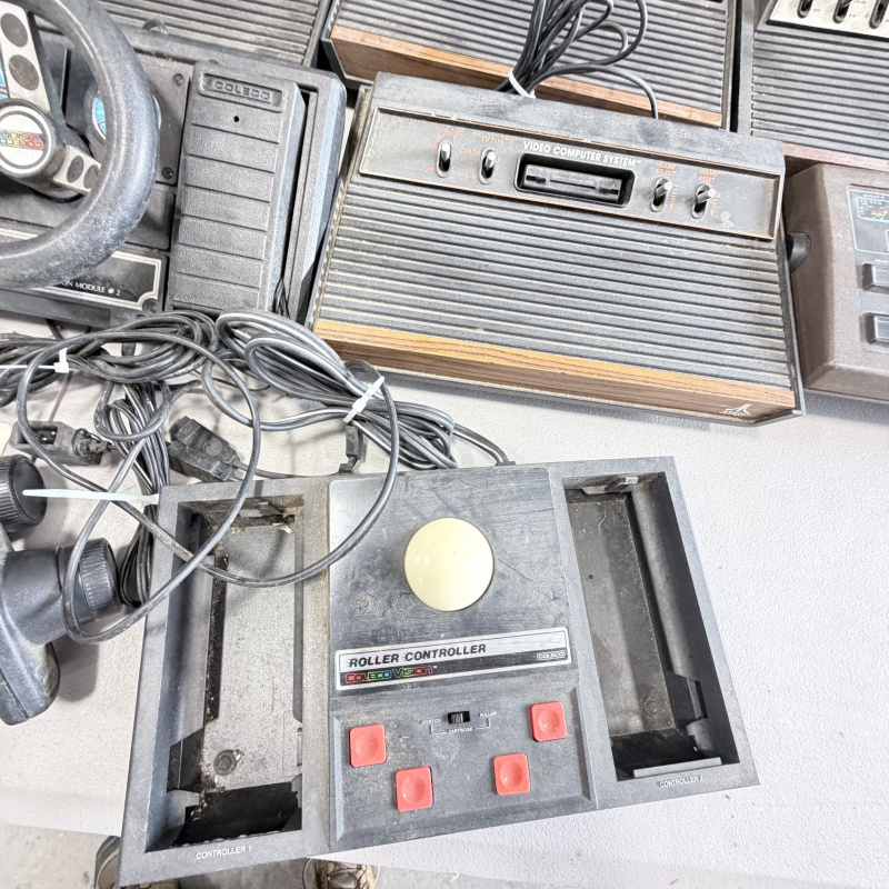 Lot 642: Vintage Atari 2600/CX2600 & ColecoVision console lot with Sears Tele-Games, controllers, joysticks and Coleco Roller Controller