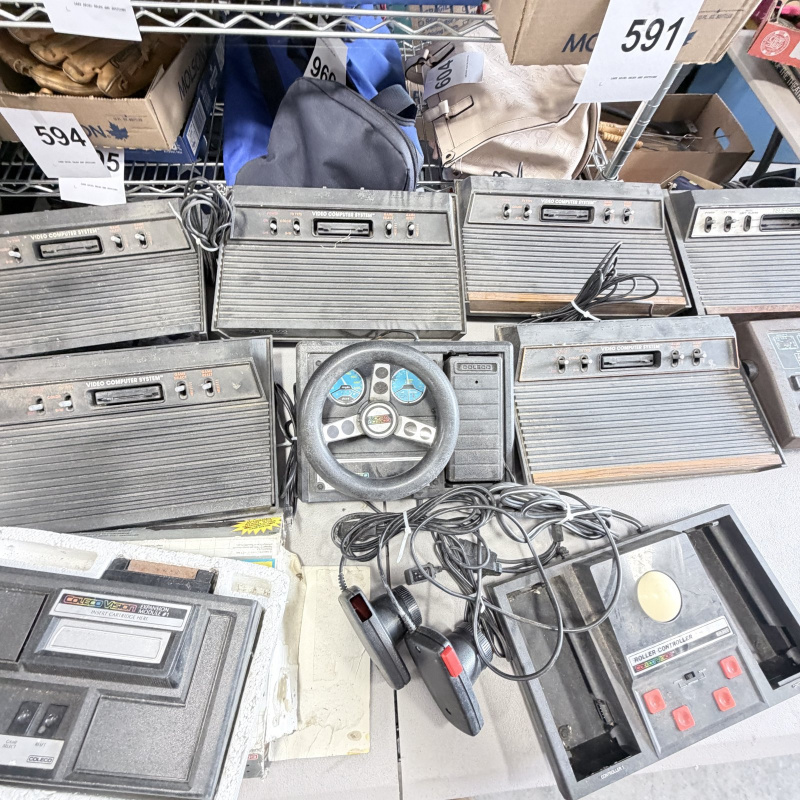 Lot 642: Vintage Atari 2600/CX2600 & ColecoVision console lot with Sears Tele-Games, controllers, joysticks and Coleco Roller Controller