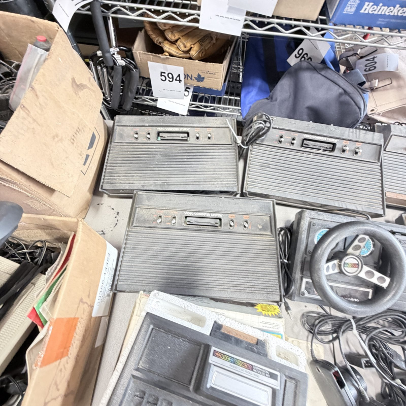 Lot 642: Vintage Atari 2600/CX2600 & ColecoVision console lot with Sears Tele-Games, controllers, joysticks and Coleco Roller Controller