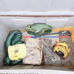 Lot 663: Craftsman gray poly job box truck tool chest with tray, contents included (hose reel, chain, circular saw)